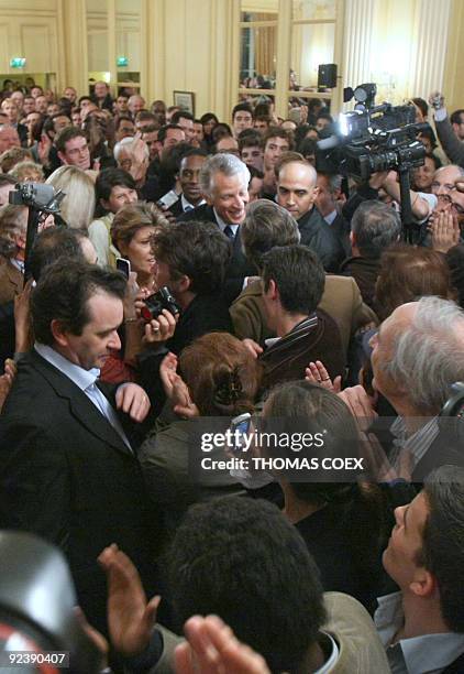 French former Prime Minister Dominique de Villepin is welcomed by his sympathisers on October 27, 2009 in Paris, upon his arrival at La maison...