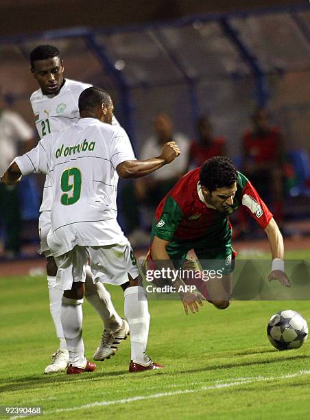 Al-Uruba's Mohammed Khamis al-Senani and Mohammed al-Mokheni commit a foul on Al-Ittifaq's Abdulrahman al-Qahtani during their GCC Clubs Championship...