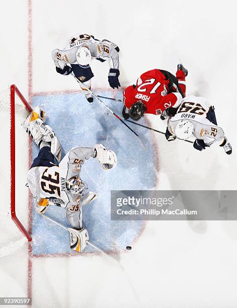 Goalie Pekka Rinne of the Nashville Predators blocks the net against Mike Fisher of the Ottawa Senators during a game at Scotiabank Place on October...