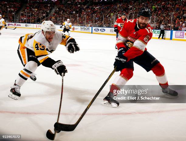 Ian McCoshen of the Florida Panthers skates for possession against Conor Sheary of the Pittsburgh Penguins at the BB&T Center on February 24, 2018 in...