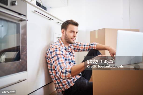 man in new apartment - browsing the internet stock pictures, royalty-free photos & images
