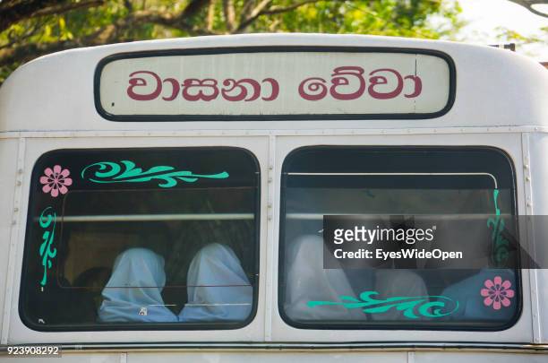Women in a local bus near Aluviharaya Rock Cave Temple on February 21, 2014 in Pinnawela, Sri Lanka.