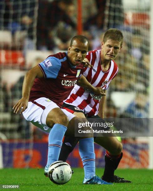 Gabriel Agbonlahor of Aston Villa holds off Michael Turner of Sunderland during the Carling Cup 4th Round match between Sunderland and Aston Villa at...