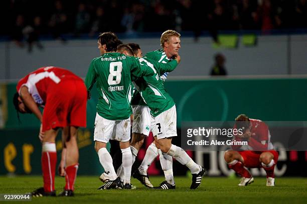 Players of Greuther Fuerth celebrates as Serdar Tasci and Thomas Hitzlsperger of Stuttgart react after the DFB Cup match between SpVgg Greuther...