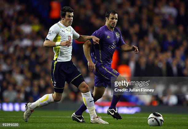 Gareth Bale of Spurs battles with Lucas Neill of Everton during the Carling Cup 4th Round match between Tottenham Hotspur and Everton at White Hart...