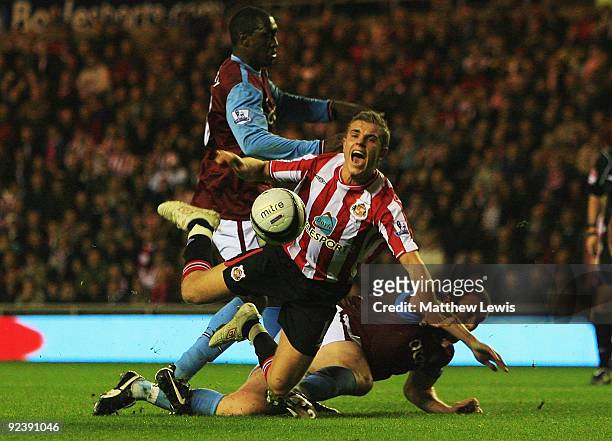 Emile Heskey and Richard Dunne of Aston Villa tackle Jordan Henderson of Sunderland during the Carling Cup 4th Round match between Sunderland and...