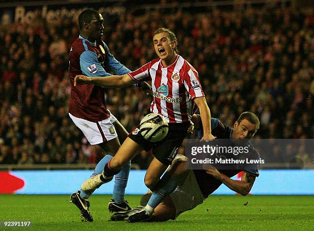 Emile Heskey and Richard Dunne of Aston Villa tackle Jordan Henderson of Sunderland during the Carling Cup 4th Round match between Sunderland and...