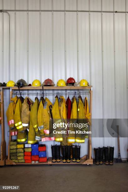 firemen's gear in firehouse - firefighter uniform stock pictures, royalty-free photos & images