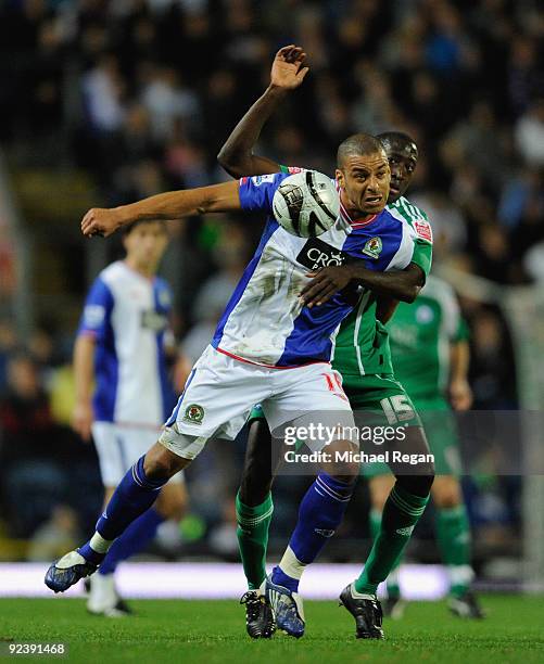 Toumani Diagouraga of Peterborough challenges Steven Reid of Blackburn during the Carling Cup 4th Round match between Blackburn Rovers and...