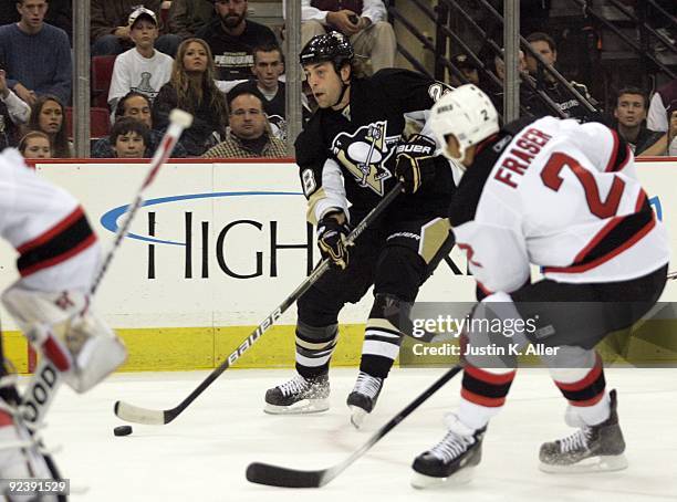Eric Godard of the Pittsburgh Penguins takes a shot on goal against the New Jersey Devils at Mellon Arena on October 24, 2009 in Pittsburgh,...