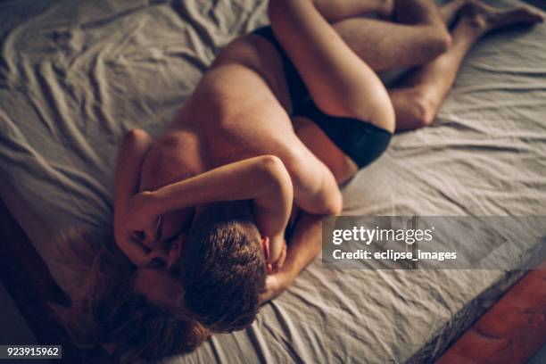 romance couple - couple in bed kissing stock pictures, royalty-free photos & images