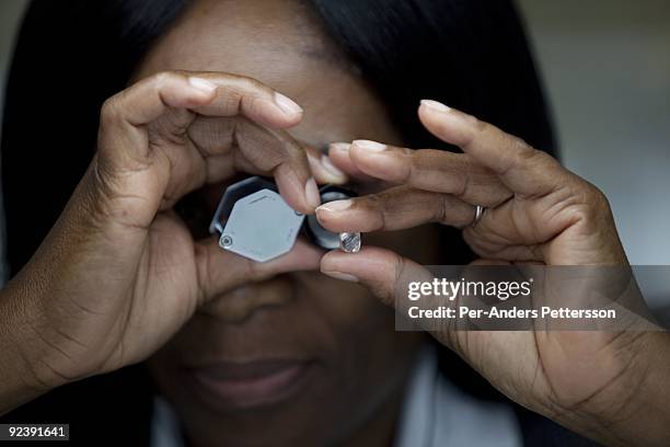 Women sorts raw diamonds at the new Diamond Trading Company , the world's largest and most advanced diamond-sorting and valuing facility on September...