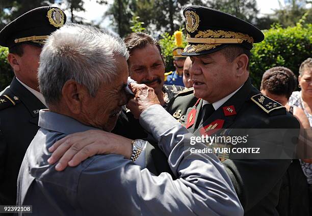 The Chief of the Honduran Armed Forces, General Romeo Vasquez Velasquez comforts the father of Colonel Concepcion Jimenez who was shot dead by...