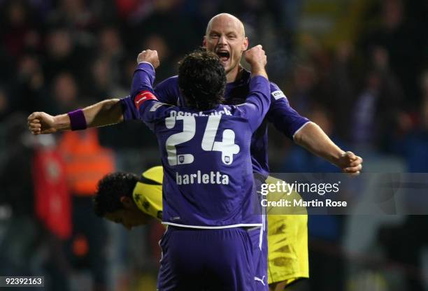 Matthias Heidrich of Osnabruck celebrates with team mate Angelo Barletta after the DFB Cup third round match between VfL Osnabrueck and Borussia...