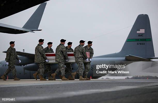 Army carry team moves the transfer case of US Army Pfc. Brandon K. Steffey, during a dignified transfer at Dover Air Force Base on October 27, 2009...