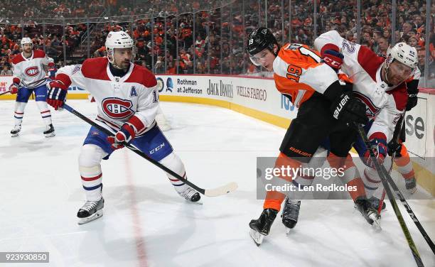 Nolan Patrick of the Philadelphia Flyers battles in the corner against Karl Alzner and Tomas Plekanec of the Montreal Canadiens on February 20, 2018...