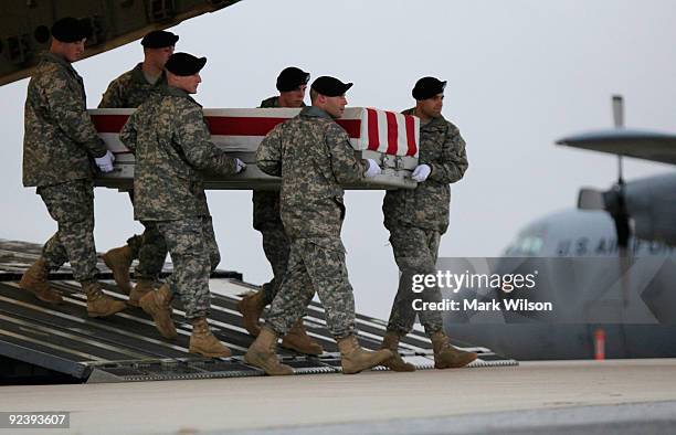 Army carry team moves the transfer case of US Army Pfc. Brandon K. Steffey, during a dignified transfer at Dover Air Force Base on October 27, 2009...