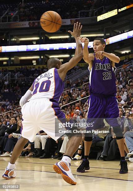 Kevin Martin of the Sacramento Kings passes the ball under pressure from the Phoenix Suns during the NBA preseason game at US Airways Center on...
