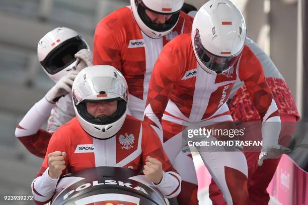 Poland's Mateusz Luty reacts with his team after the 4-man bobsleigh heat 4 final run during the Pyeongchang 2018 Winter Olympic Games at the Olympic...