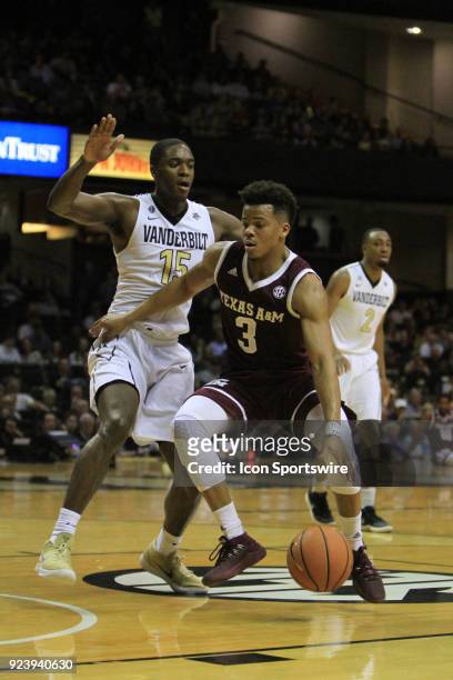 Vanderbilt Commodores forward Clevon Brown defends Texas A&M Aggies guard Admon Gilder as he drives to the basket in the first half of a Southeastern...