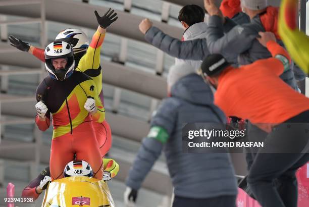 The team led bny Germany's Francesco Friedrich celebrates the gold after the 4-man bobsleigh heat 4 final run during the Pyeongchang 2018 Winter...