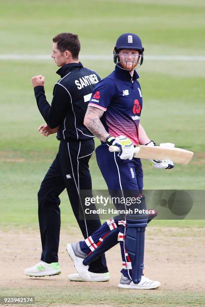 Ben Stokes of England walks off as Mitchell Santner of the Black Caps celebrates his wicket during game one in the One Day International series...