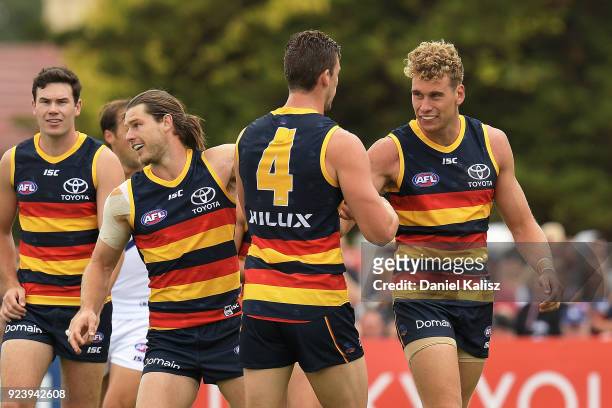 Harry Dear of the Crows celebrates with Josh Jenkins of the Crows and Bryce Gibbs of the Crows after kicking a goal during the JLT Community Series...