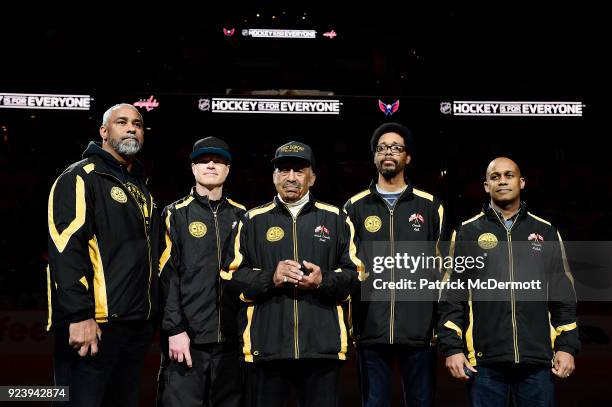Fort Dupont hockey coaches Hank Lee, John Connor, Neal Henderson, Robert Primus, and Ralph Featherstone participate in a ceremonial puck drop before...