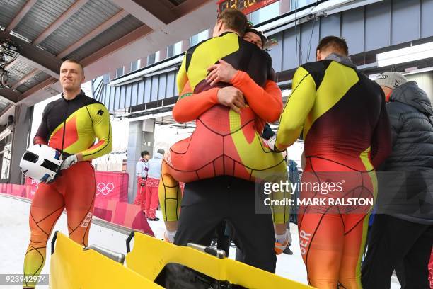 Germany's Francesco Friedrich's team reacts after winning the 4-man bobsleigh heat 4 final run during the Pyeongchang 2018 Winter Olympic Games at...