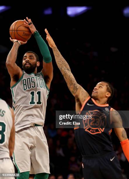 Kyrie Irving of the Boston Celtics takes a shot as Trey Burke of the New York Knicks defends at Madison Square Garden on February 24,2018 in New York...