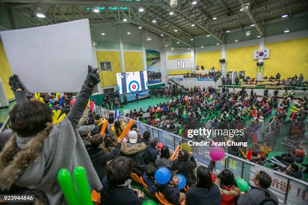 Fans, mostly comprised with Uiseong residents, cheer for the South Korean curling team at Uiseong Gymnasium on February 25, 2018 in Uiseong-gun,...