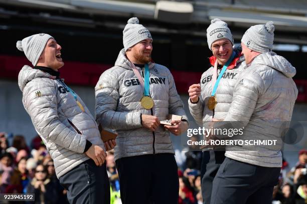 Gold medallists Germany's Francesco Friedrich, Martin Grothkopp, Candy Bauer and Thorsten Margis laugh on the podium after the medal ceremony for the...