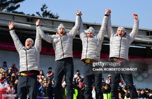 Gold medallists Germany's Thorsten Margis, Martin Grothkopp, Candy Bauer and Francesco Friedrich celebrate on the podium for the 4-man bobsleigh...