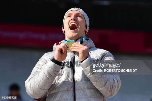 Gold medallist Germany's Thorsten Margis reacts on the podium during the medal ceremony for the 4-man bobsleigh during the Pyeongchang 2018 Winter...