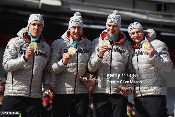 Gold medalists Francesco Friedrich, Candy Bauer, Martin Grothkopp and Thorsten Margis of Germany celebrate on the podium during the medal ceremony...