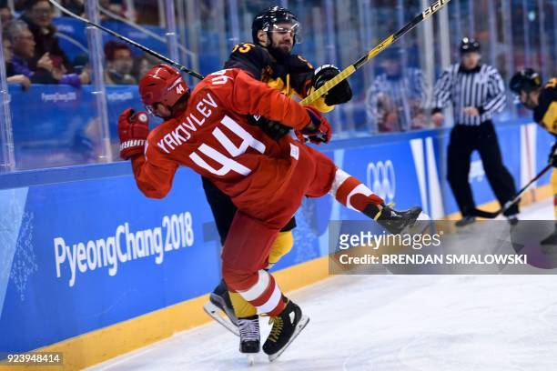 Germany's Felix Schutz collides with Russia's Yegor Yakovlev in the men's gold medal ice hockey match between the Olympic Athletes from Russia and...