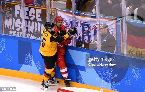 Felix Schutz of Germany collides with Mikhail Grigorenko of Olympic Athlete from Russia in the first period during the Men's Gold Medal Game on day...