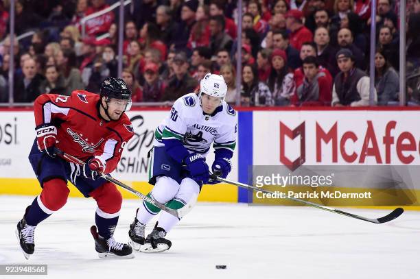 Evgeny Kuznetsov of the Washington Capitals skates with the puck against Markus Granlund of the Vancouver Canucks in the first period at Capital One...