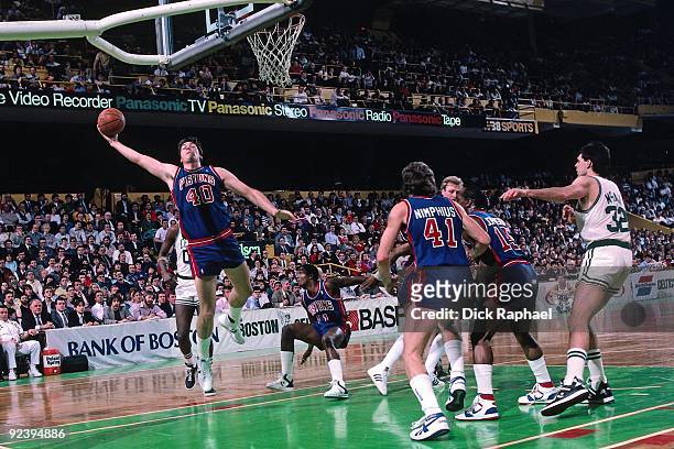 Bill Laimbeer of the Detroit Pistons rebounds against the Boston Celtics during a game played in 1987 at the Boston Garden in Boston, Massachusetts....