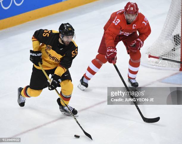 Germany's Felix Schutz tries to get past Russia's Pavel Datsyuk in the men's gold medal ice hockey match between the Olympic Athletes from Russia and...
