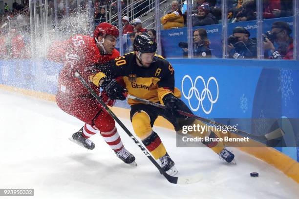 Bogdan Kiselevich of Olympic Athlete from Russia competes for the puck against Patrick Hager of Germany in the first period during the Men's Gold...