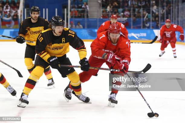 Christian Ehrhoff of Germany competes for the puck with Ivan Telegin of Olympic Athlete from Russia in the first period during the Men's Gold Medal...