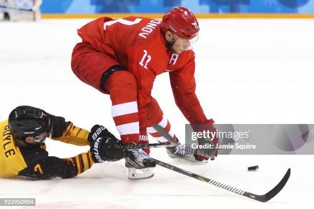 Daryl Boyle of Germany competes for the puck with Sergei Andronov of Olympic Athlete from Russia in the first period during the Men's Gold Medal Game...