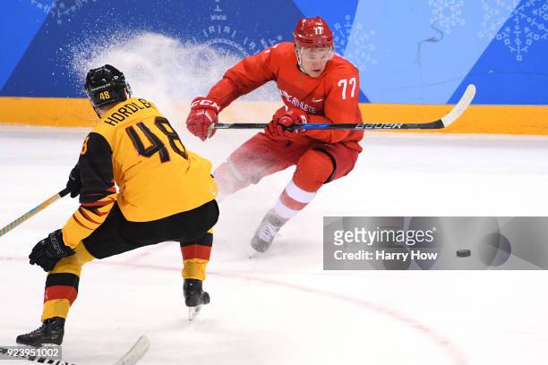 Kirill Kaprizov of Olympic Athlete from Russia controls the puck against Frank Hordler of Germany in the first period during the Men's Gold Medal...