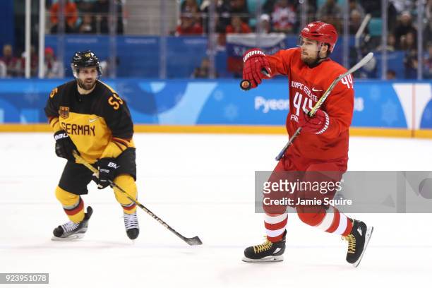 Yegor Yakovlev of Olympic Athlete from Russia collects the puck in the first period against Felix Schutz of Germany during the Men's Gold Medal Game...