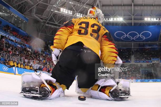 Germany's Danny aus den Birken lets in a goal by Russia's Vyacheslav Voinov in the men's gold medal ice hockey match between the Olympic Athletes...