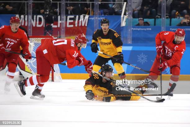 Marcel Noebels of Germany competes for the puck with Sergei Mozyakin and Pavel Datsyuk of Olympic Athlete from Russia in the first period during the...