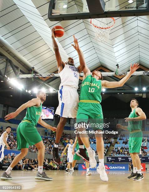 Quincy Spencer Davis III of Chinese Taipei shoots past Matt Hodgson of the Boomers during the FIBA World Cup Qualifying match between the Australian...