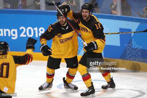 Felix Schutz of Germany celebrates with Brooks Macek after scoring a goal in the second period against Olympic Athletes from Russia during the Men's...