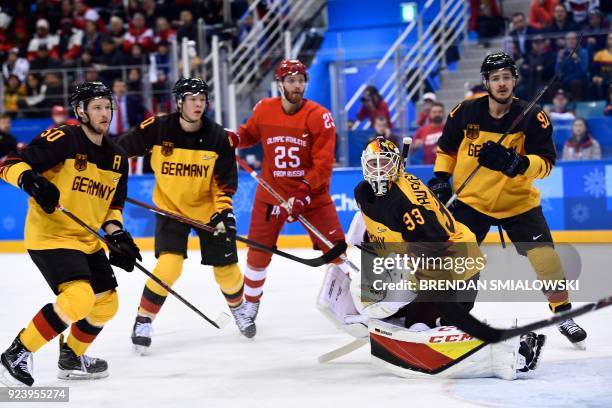 Players watch a play in the men's gold medal ice hockey match between the Olympic Athletes from Russia and Germany during the Pyeongchang 2018 Winter...